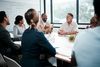 Teammates at table in meeting