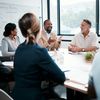 Teammates at table in meeting