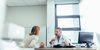 Doctor and staffer having a discussion in a hospital office